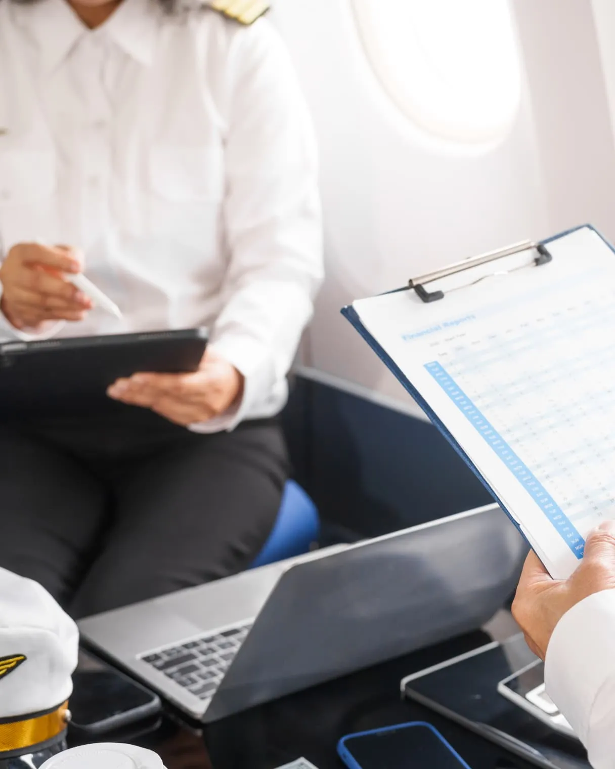 Pilots reviewing reports and flight documents in an aircraft cabin