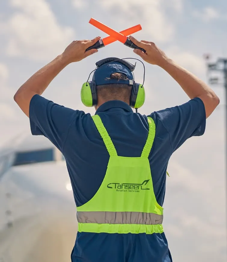Tahseen Aviation ground handler signalling with marshalling wands
